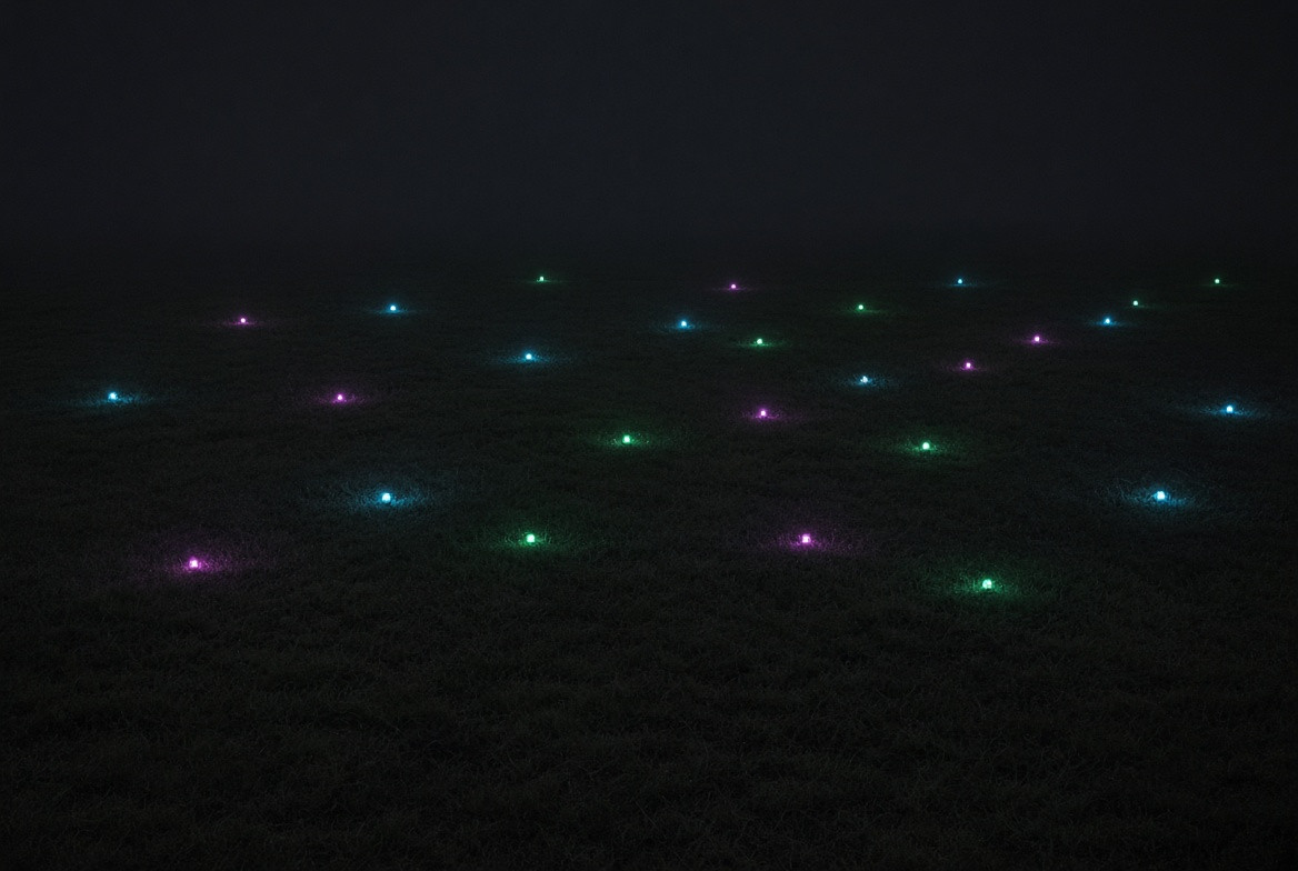 A constellation of practical lights over a fictional field